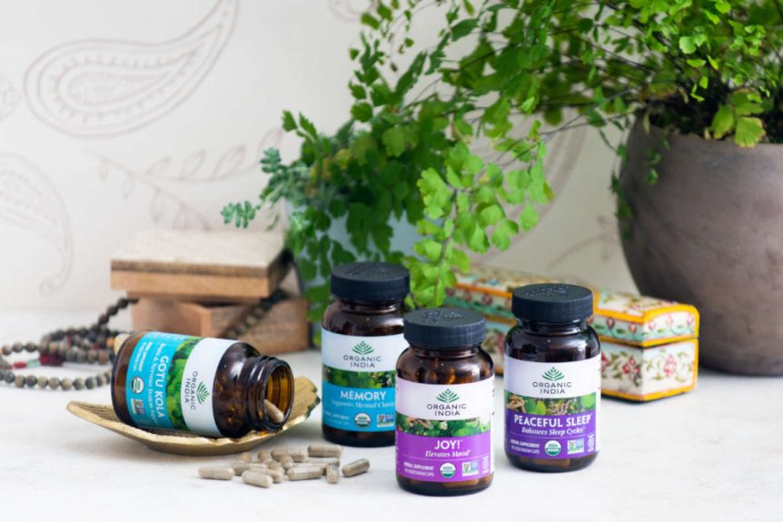 4 adaptogens vs nootropics capsules on a marble table with plant.