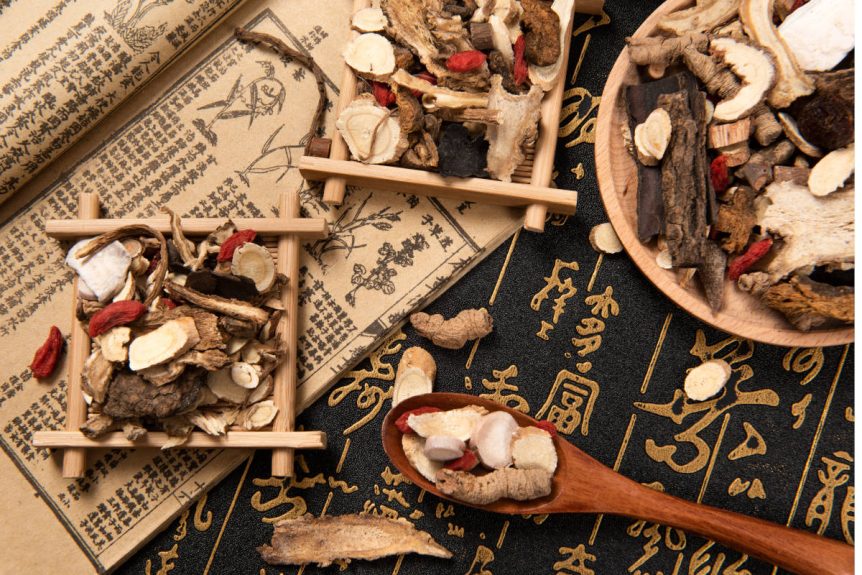 Ashwagandha in tcm on a desk with traditional chinese medicine tools and herbs