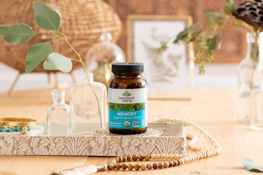 Bacopa with Gotu Kola in this organic memory supplement on an ornate platter on wood table with mala bead necklance.