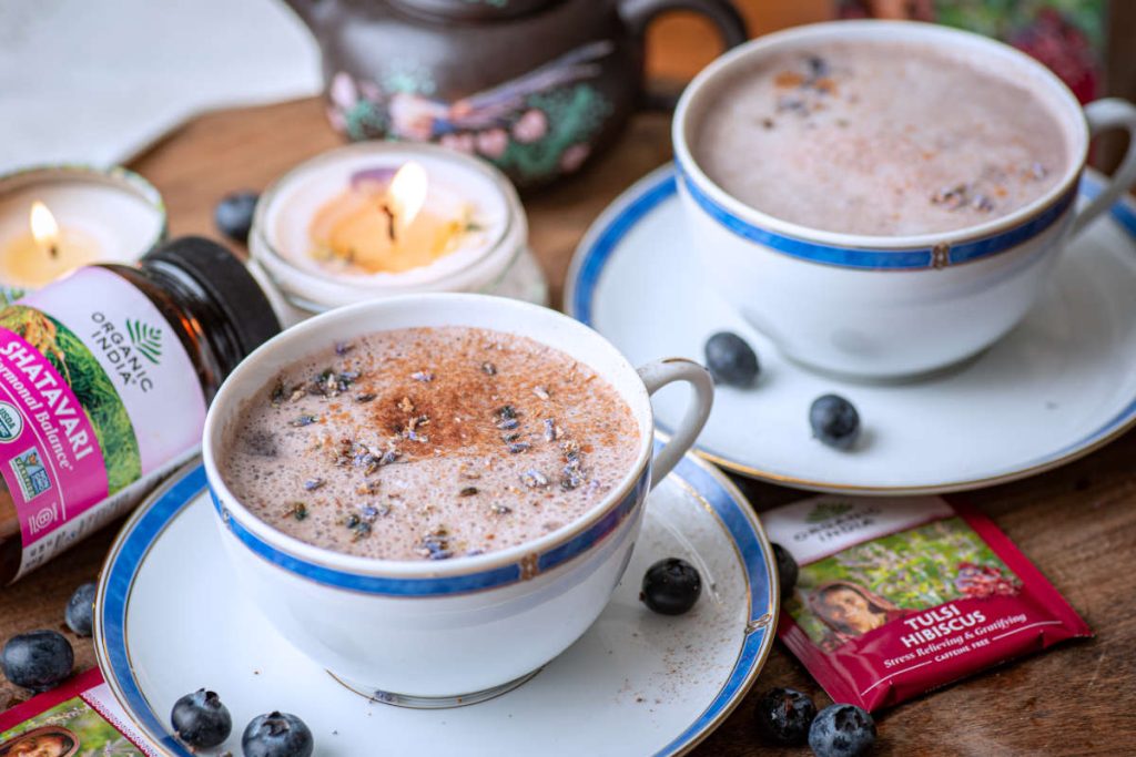 Blue moon milk with tulsi and shatavari with lavendar and fresh blueberry garnish and candle.