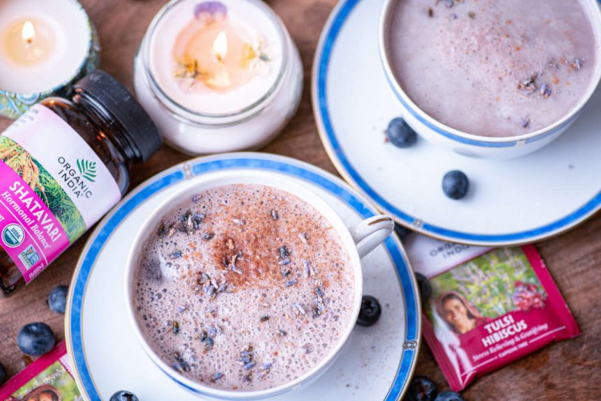 Blue moon milk with tulsi and shatavari with lavendar and fresh blueberry garnish and candle.