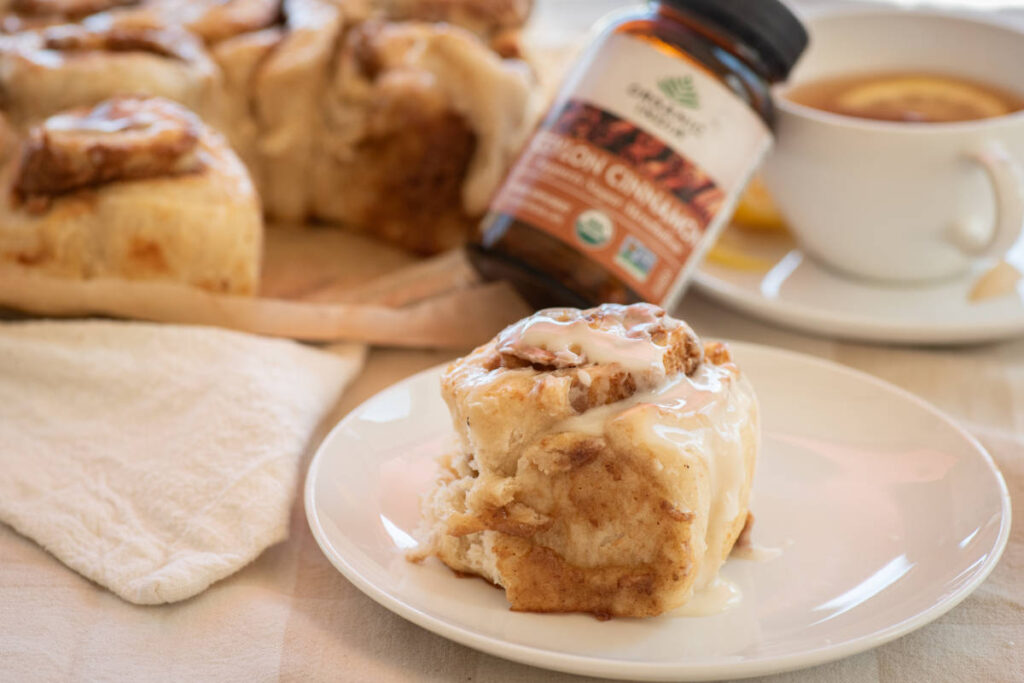 Ceylon cinnamon rolls masala chai tea pairings on a white plate with a teacup of tea