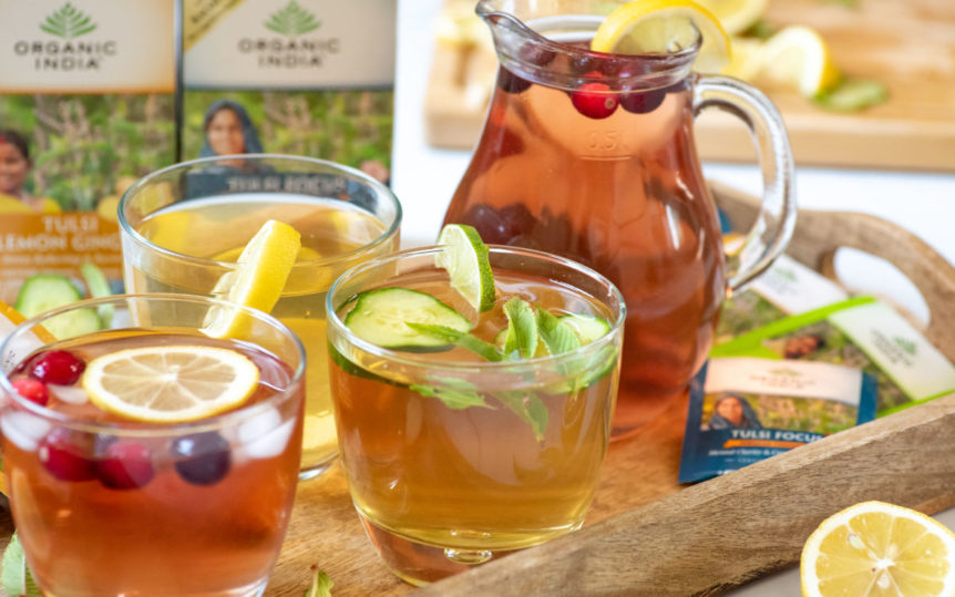 Detox Iced tea 3 differenet ones with lemons, cranberries and mint as garnish.