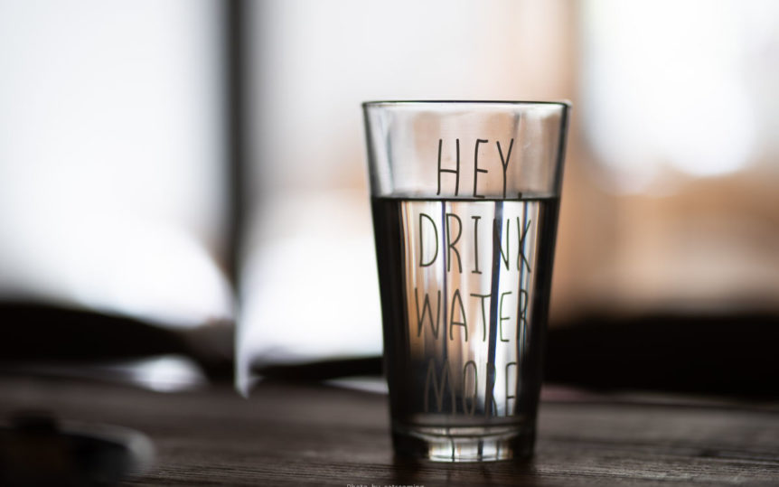 A glass of water that says hey drink more water, which is important for liver and kidney health.