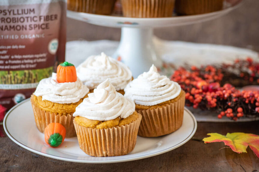 Gluten Free Pumpkin Cupcakes with Cinnamon Cashew Frosting on a plate.