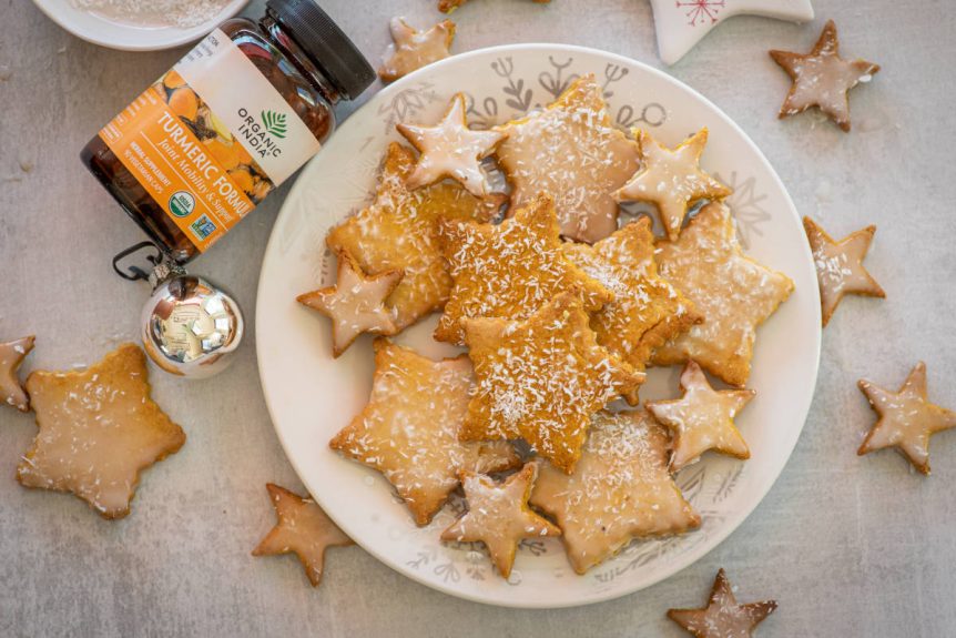 Golden milk cookies with turmeric on a white plate shaped like stars.