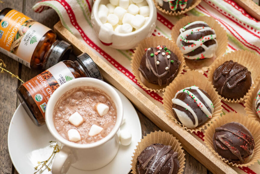 DIY hot chocolate spheres on a wooden tray and hot chocolate in a white mug