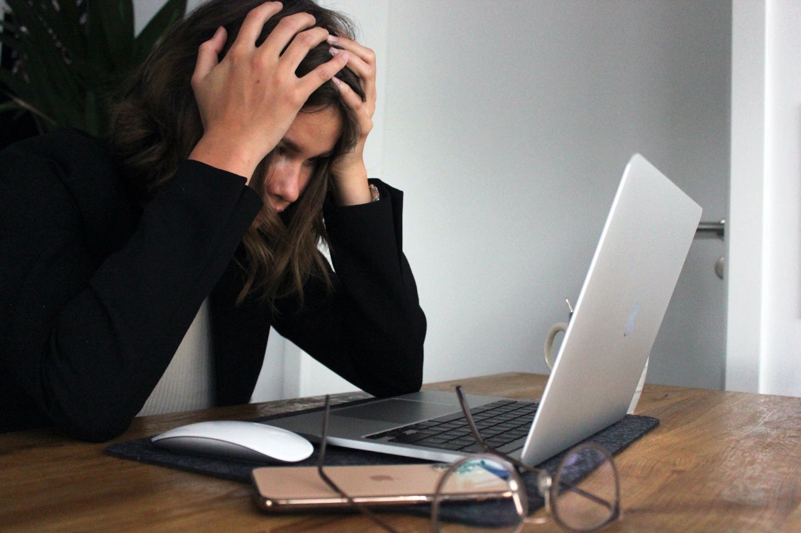 Woman sitting at computer stressed out in need for herbs for stress relief. 