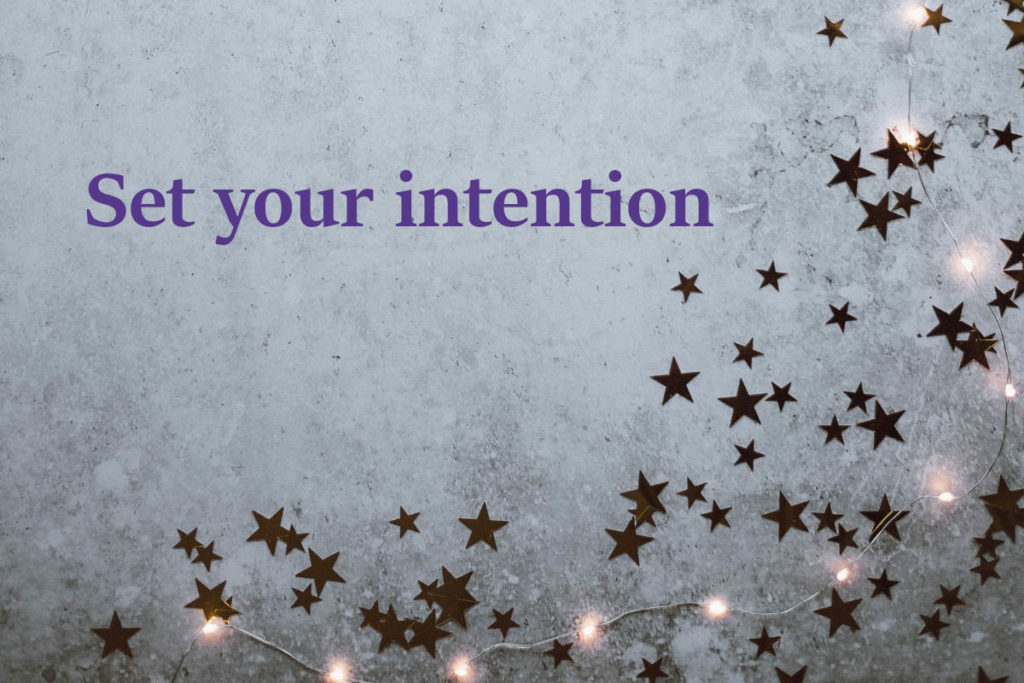 Concrete ground with star decor, twinkle lights and the words "set your intention."