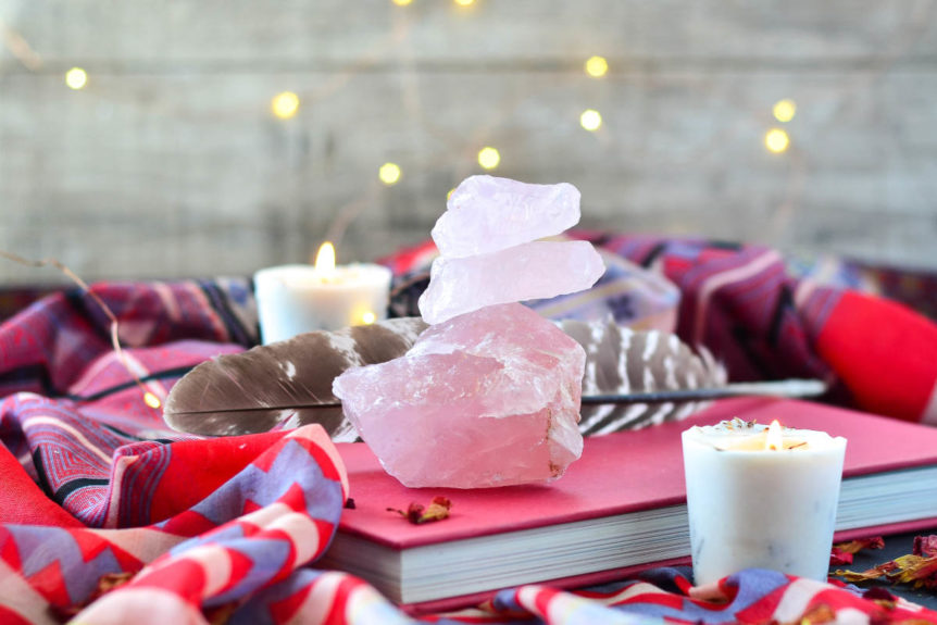 book, crystals and candles for an intention setting ritual.