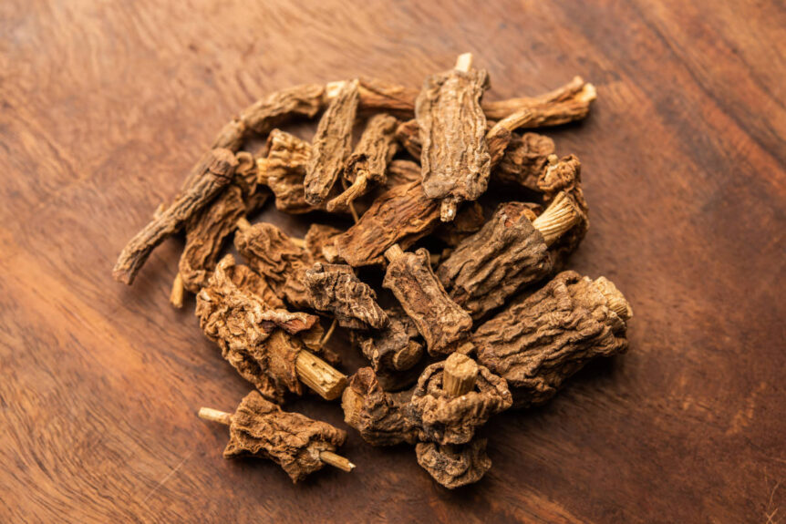 Loose whole lodhra stem bark for women on wood table.