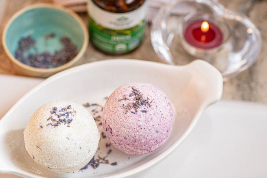 Neem bath melts, spherical shape with dried lavender garnish and candle.