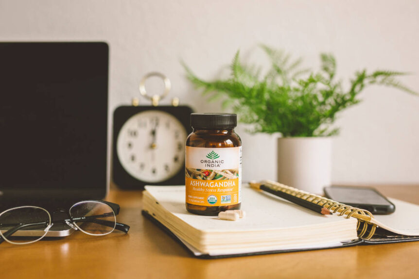 Ashwagandha capsules on notebook on desk.