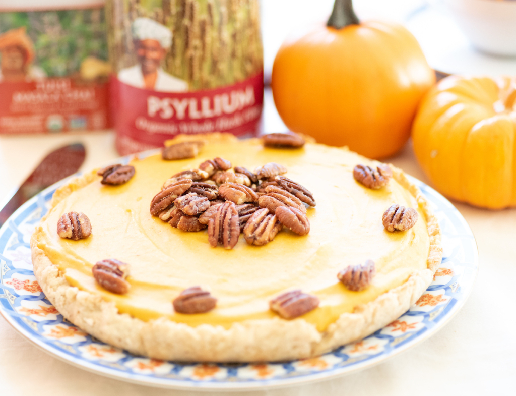 Healthy holiday feasts complete with a gluten-free pumpkin pie garnished with pecan.