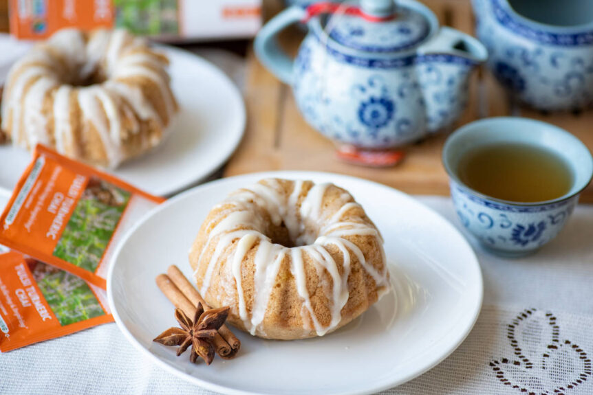 Tulsi chai tea cakes on white plate with cinnamon and clove garnish and blue asian-inspired teapot.