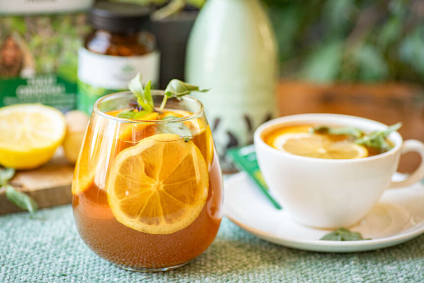 Immunity elixir featuring neem and tulsi in a glass on a green tablecloth