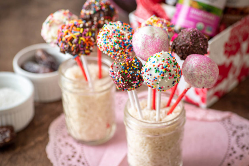 Cup of rice to hold pink, white and chocolate valentine's day cake pop recipe.